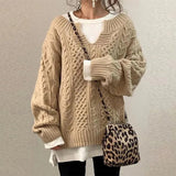 Beige cable-knit oversized sweater with V-neck, long sleeves, ribbed cuffs and hem