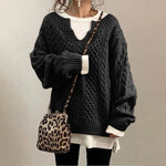 Black cable-knit oversized sweater with V-neck, long sleeves, ribbed cuffs and hem