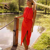 Sleeveless orange midi dress with gathered neckline and side slit, flowing drape