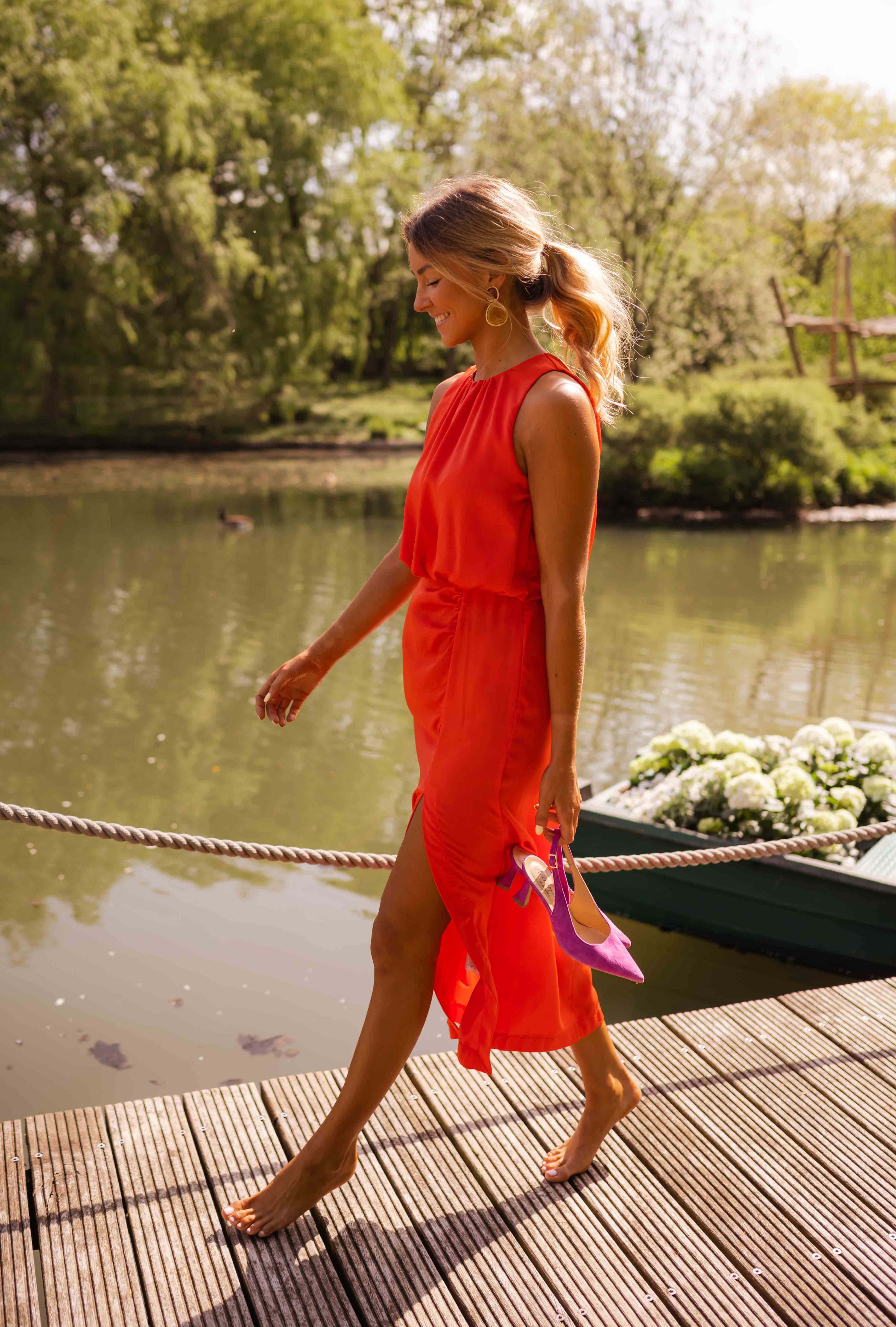 Orange sleeveless midi dress with gathered waist detail and front slit