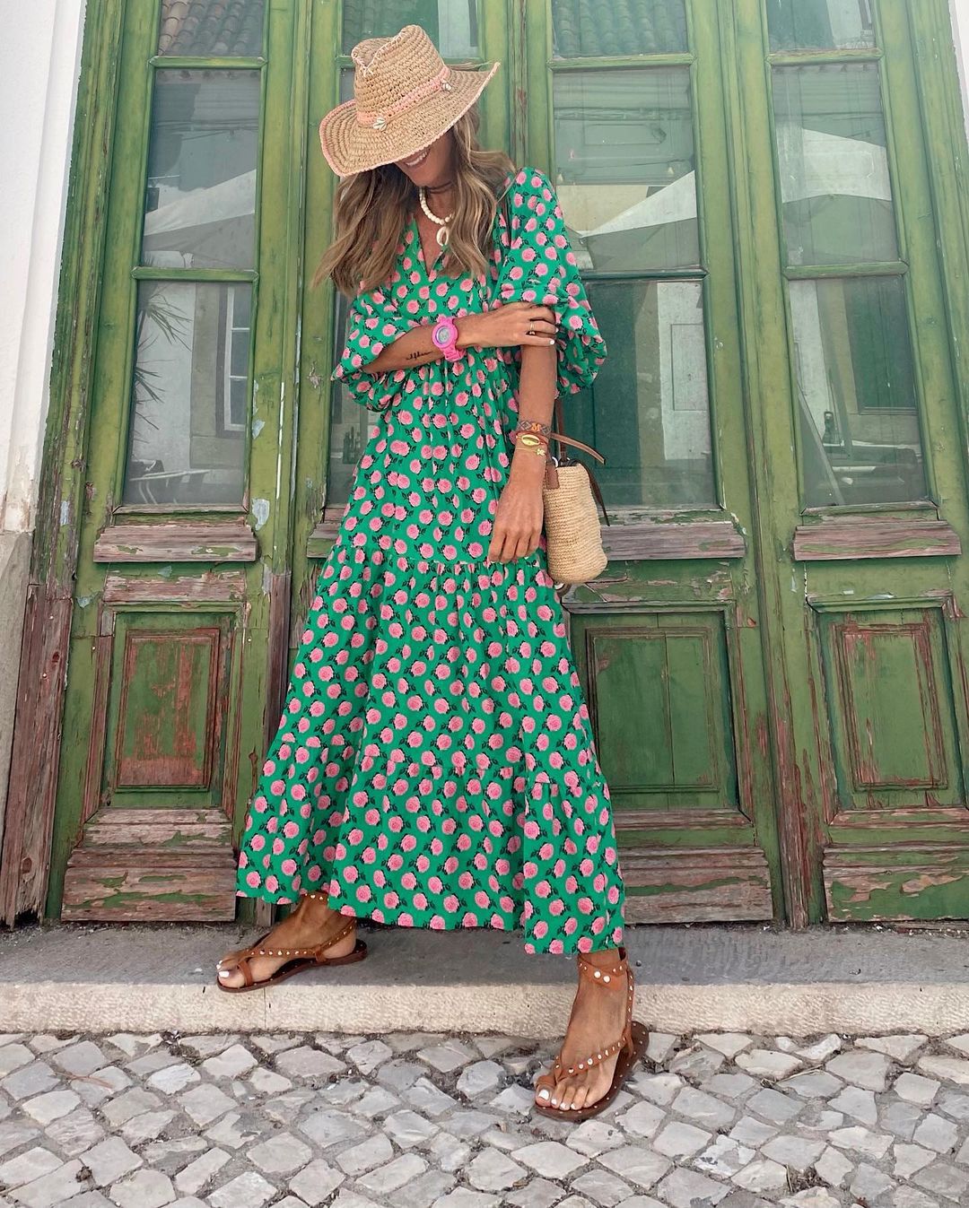 Bohemian maxi dress in green with pink floral print, flowing tiered skirt