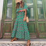 Bohemian maxi dress in green with pink floral print, flowing tiered skirt