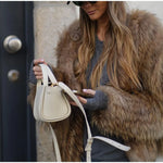 Cropped brown faux-fur jacket close-up, open front and long sleeves