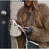 Cropped brown faux-fur jacket close-up, open front and long sleeves