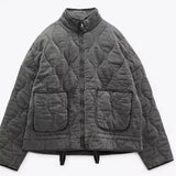 Gray cropped quilted jacket with stand collar, full zip, and flap pockets