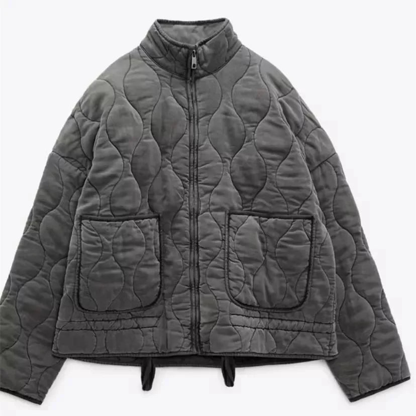Gray cropped quilted jacket with stand collar, full zip, and flap pockets