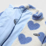 Light blue zip-up jacket with heart-pattern sherpa collar and small chest patch