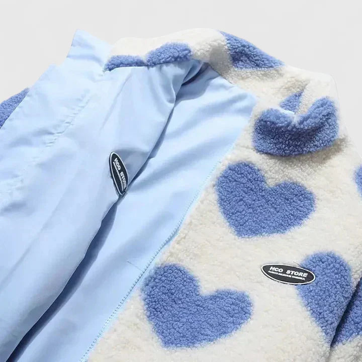 Light blue zip-up jacket with heart-pattern sherpa collar and small chest patch