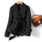 Black quilted puffer jacket with wrap front, tie belt, and long sleeves
