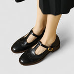 Black leather-style Mary Jane shoes with side buckle strap and low block heel