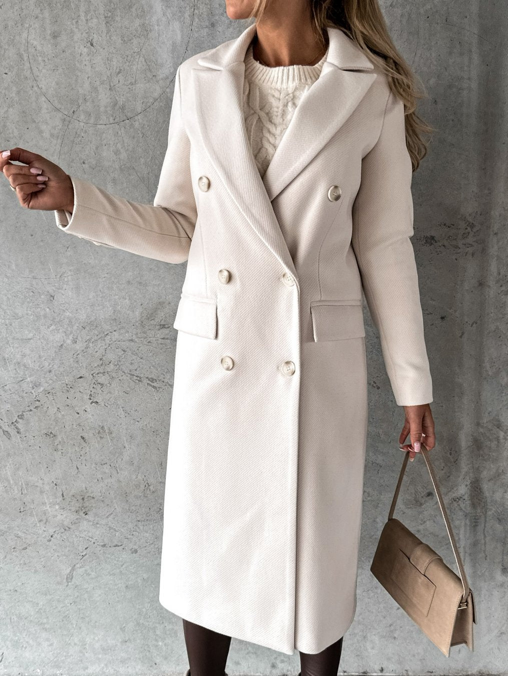 Cream double-breasted overcoat with notch lapels, long sleeves, and front button rows