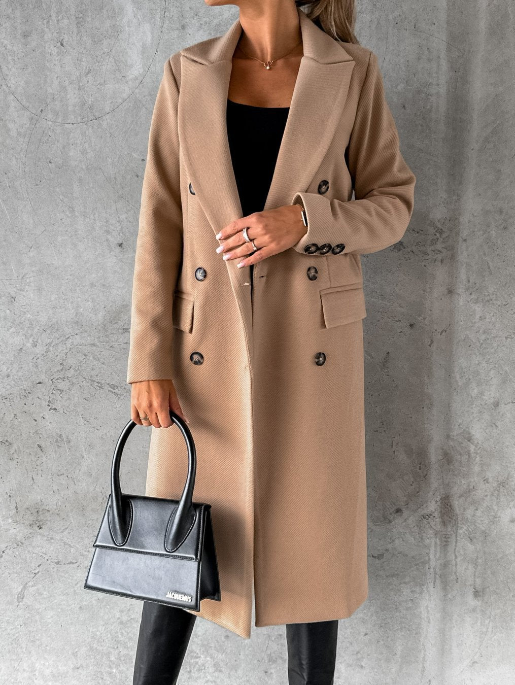 Beige double-breasted overcoat with notch lapels, long sleeves, and buttoned flap pockets