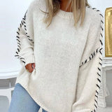Cream chunky knit pullover with textured sleeves and visible side contrast stitching