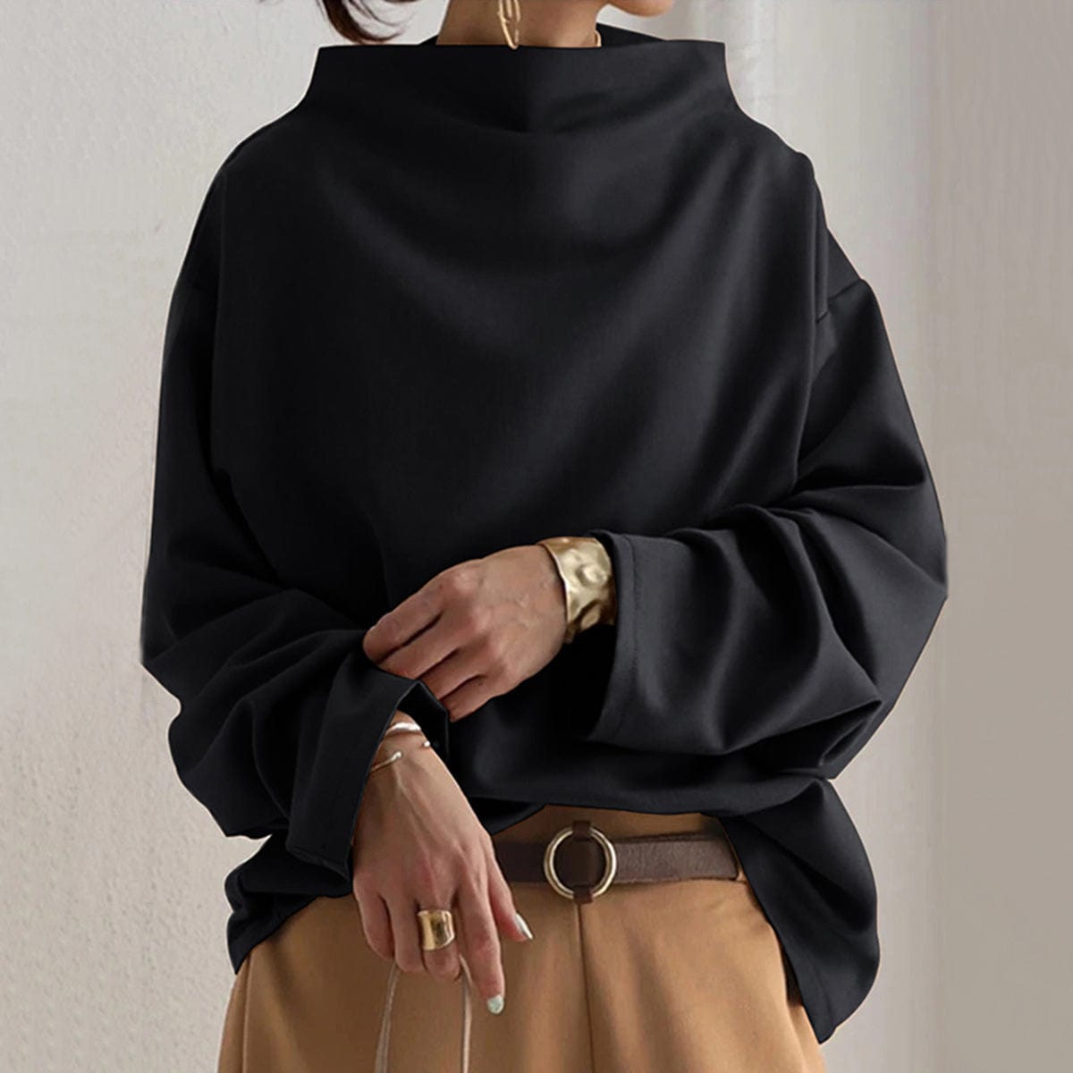 Black high-neck soft knit top with relaxed fit and long sleeves