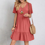 Coral pink V-neck tiered midi dress with short sleeves and gathered tiers
