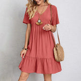 Coral pink V-neck tiered midi dress with short sleeves and gathered tiers