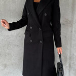 Black double-breasted overcoat with notch lapels, long sleeves, and large button details