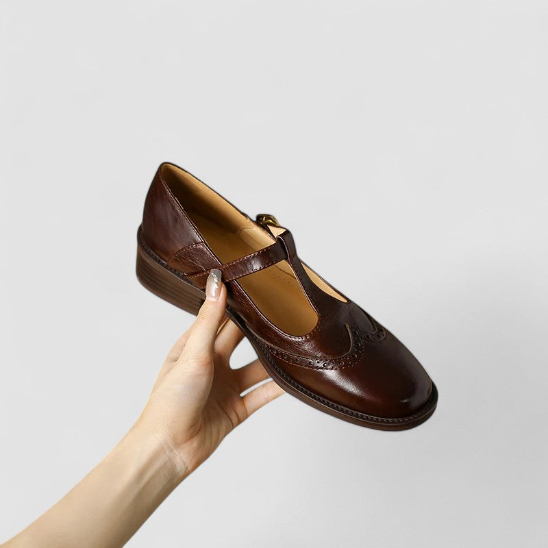 Brown leather Mary Jane shoe with buckle strap and low block heel, side view