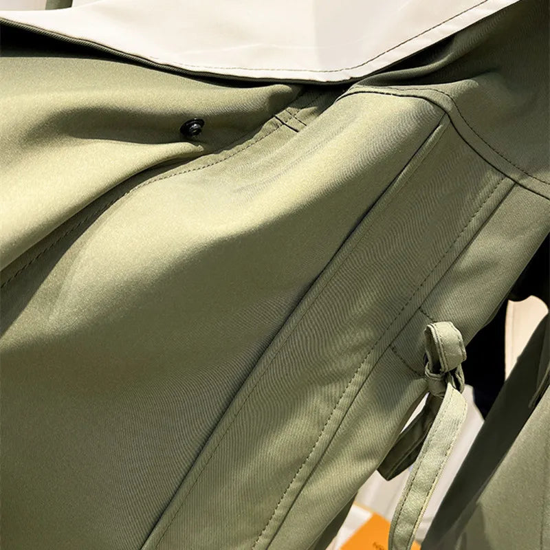 Olive green windbreaker jacket front with drawstring hood and zipper pull