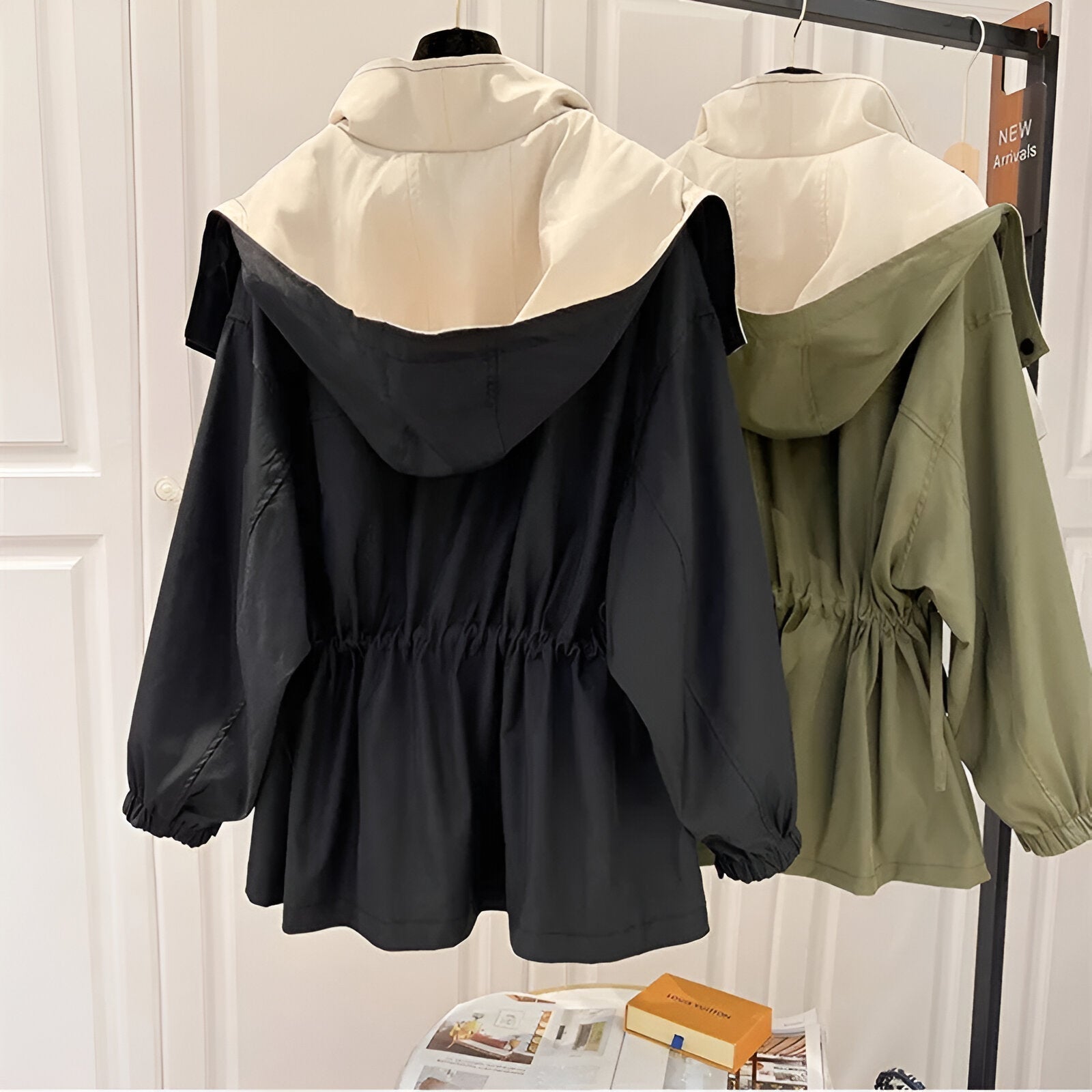 Hooded windproof weatherproof jackets on hangers: black and olive green