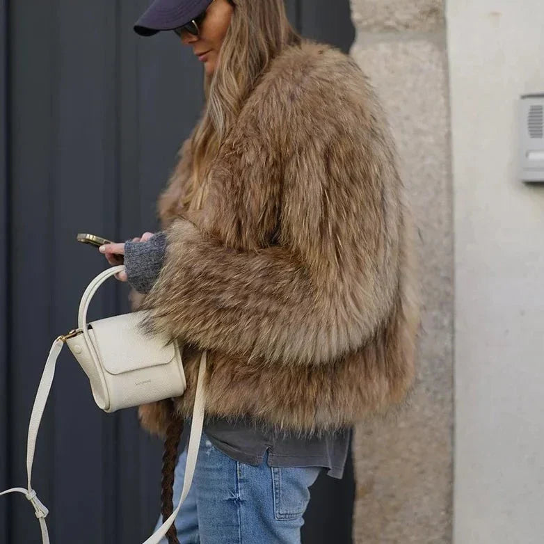 Cropped brown faux-fur jacket close-up, thick shaggy texture and long sleeves