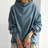 Blue high-neck soft knit top with relaxed fit and draped long sleeves