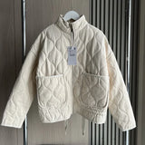 Light cream cropped quilted jacket with full zip, flap pockets, and drawstring hem