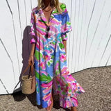 Bohemian maxi dress with bright blue, pink, and green floral print, V-neck, buttons