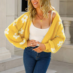 Yellow cropped V-neck cardigan with long sleeves and white floral pattern