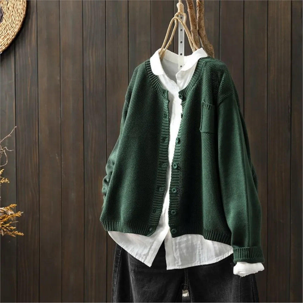 Green knit cardigan with button front, patch pockets, ribbed cuffs and hem.