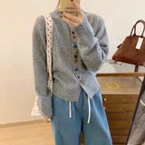 Light gray knit cardigan with long sleeves, ribbed cuffs, and multicolor button front