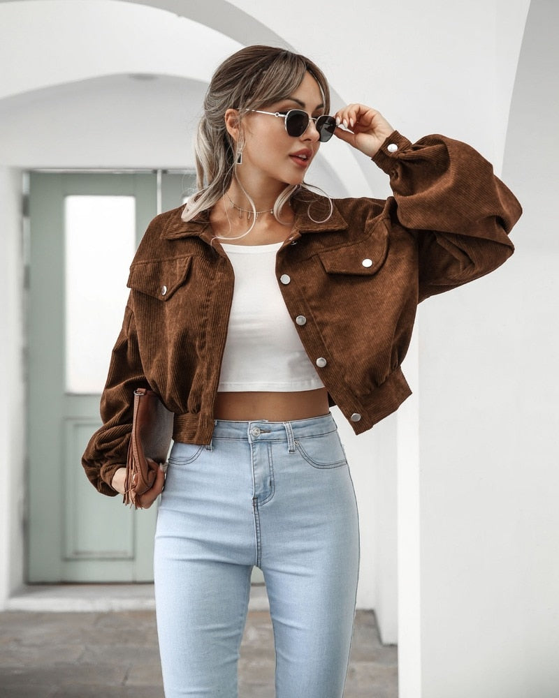 Brown cropped jacket with flap pockets and button front, long puff sleeves