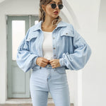 Light blue cropped jacket with flap pockets and button front, long puff sleeves