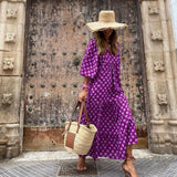 Bohemian maxi dress in purple with small white dot pattern and elbow-length sleeves