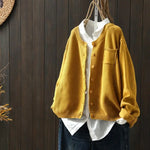 Mustard yellow knit cardigan with button front, patch pockets, ribbed cuffs and hem.