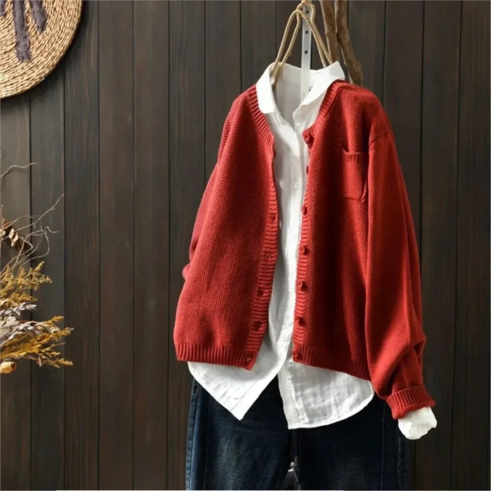 Red knit cardigan with button front, patch pockets, ribbed cuffs and hem.