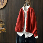 Red knit cardigan with button front, patch pockets, ribbed cuffs and hem.