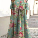 Mint green midi dress with pink floral print, gathered waist and short sleeves