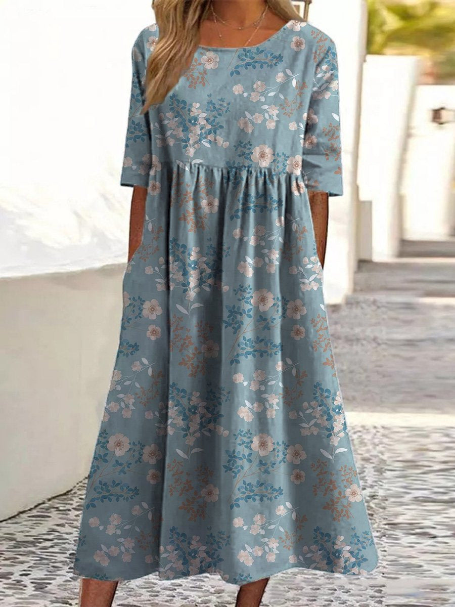 Light blue midi dress with small floral print, short sleeves, gathered empire waist