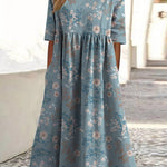 Light blue midi dress with small floral print, short sleeves, gathered empire waist