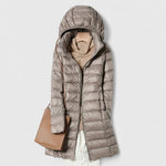 Long hooded puffer jacket with front zipper and long sleeves, taupe gray colorway.
