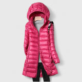 Hooded long puffer jacket with front zipper, hot pink colorway with quilted texture.