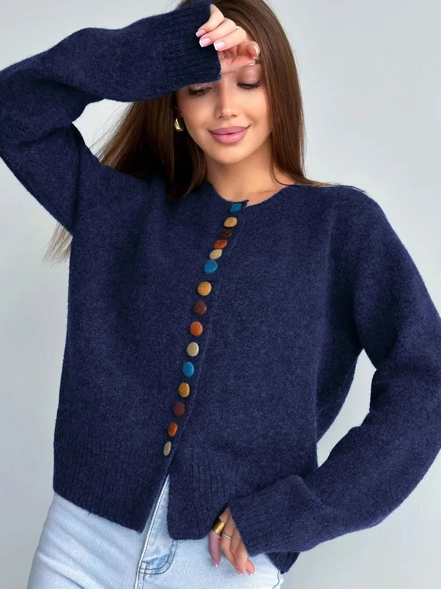 Navy knit cardigan with long sleeves and vertical row of multicolor round buttons