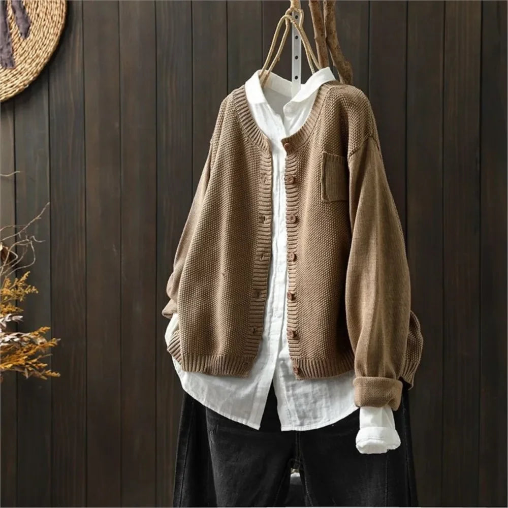 Camel knit cardigan with button front, patch pockets, ribbed cuffs and hem.