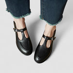 Black Mary Jane shoes with low heel, T-strap and metal buckle, side view