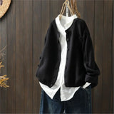 Black knit cardigan with button front, patch pockets, ribbed cuffs and hem.