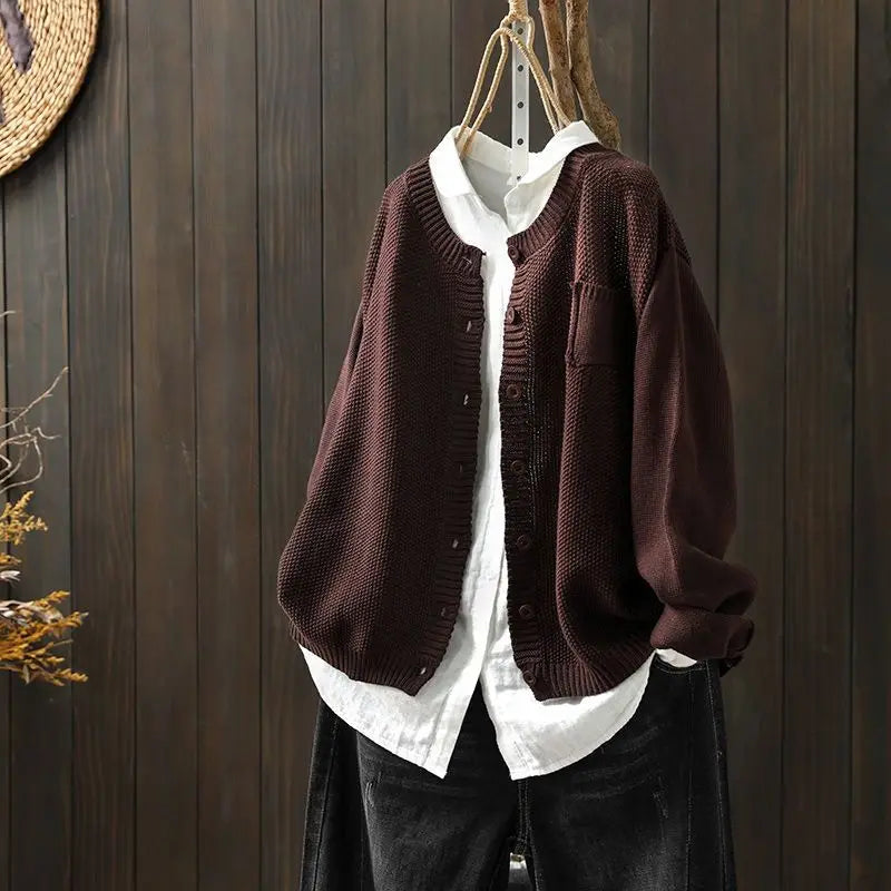 Brown knit cardigan with button front, patch pockets, ribbed cuffs and hem.