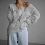 White fuzzy cardigan with V-neck and button front, relaxed shoulder fit