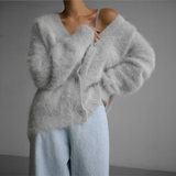 White fuzzy cardigan with V-neck and button front, relaxed shoulder fit