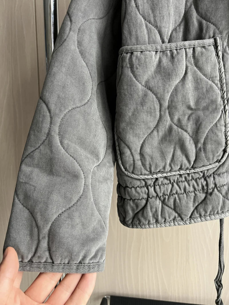 Gray cropped quilted jacket sleeve and pocket with drawstring hem